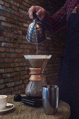 Image showing Barista brewing coffee