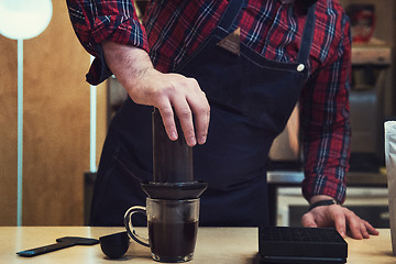 Image showing Barista brewing aeropress coffee