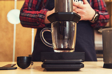 Image showing Barista brewing aeropress coffee