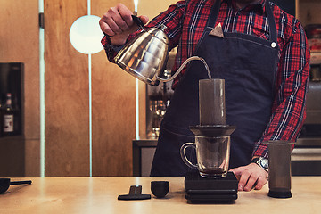 Image showing Barista brewing aeropress coffee