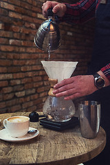 Image showing Barista brewing coffee