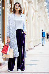 Image showing beautiful woman with shopping bags in a big store