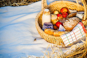 Image showing Bread, milk and apples in a basket.