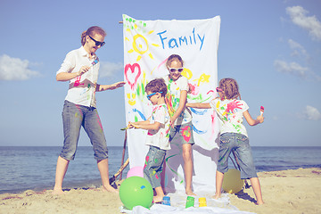 Image showing Mother and children playing on the beach at the day time.