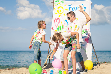 Image showing Father and children playing on the beach at the day time.