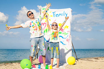 Image showing Father and daughter playing on the beach at the day time.