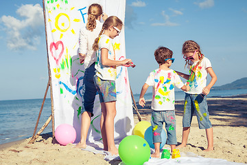 Image showing Mother and children playing on the beach at the day time.