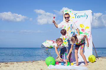 Image showing Father and children playing on the beach at the day time.