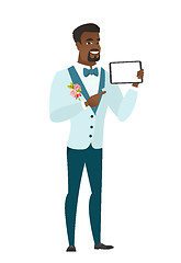 Image showing Smiling groom holding tablet computer.