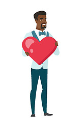 Image showing African-american groom holding a big red heart.