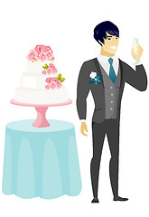 Image showing Groom standing near cake with glass of champagne.