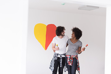 Image showing couple with painted heart on wall