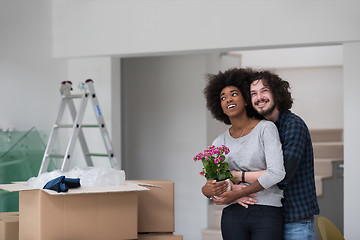 Image showing multiethnic couple moving into a new home