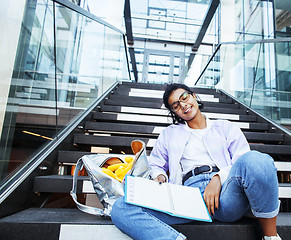 Image showing young cute indian girl at university building sitting on stairs 