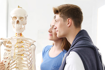 Image showing Schoolgirl watching model of a human skeleton.