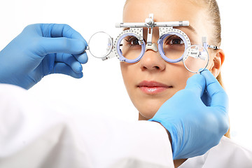 Image showing Ophthalmologist, selection of corrective lenses.