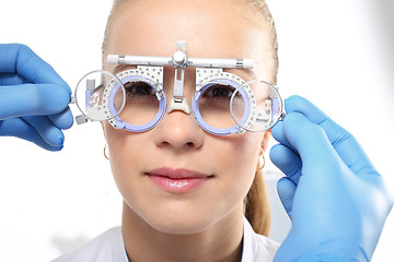 Image showing Selection of spectacles, woman ophthalmologist. The patient at an ophthalmologist, selection of eyeglass