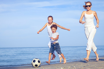 Image showing Mother and children playing on the beach at the day time.