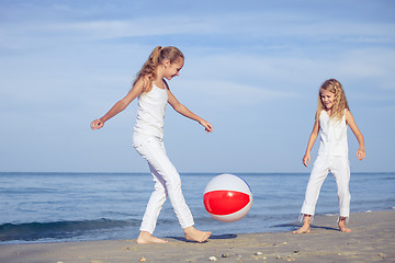 Image showing Two sisters playing on the beach at the day time.