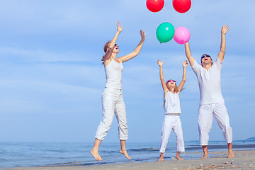 Image showing Happy family playing on the beach at the day time.