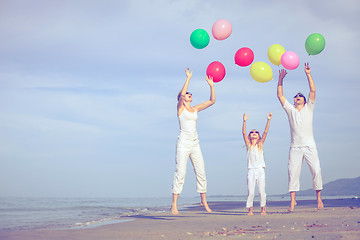 Image showing Happy family playing on the beach at the day time.