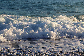 Image showing Sea waves and white foam on the evening coast