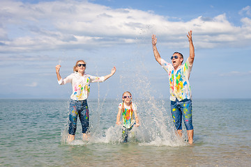 Image showing Happy family playing on the beach at the day time.