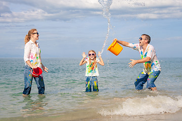 Image showing Happy family playing on the beach at the day time.