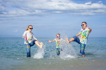 Image showing Happy family playing on the beach at the day time.