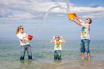 Image showing Happy family playing on the beach at the day time.