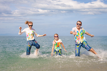 Image showing Happy family playing on the beach at the day time.