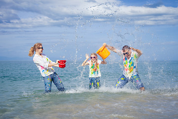 Image showing Happy family playing on the beach at the day time.