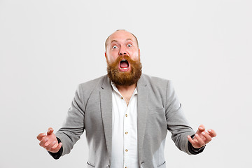 Image showing Upset screaming man on empty background