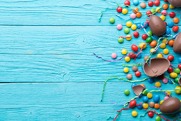 Image showing Multi-colored sweets, chocolate eggs, ribbon