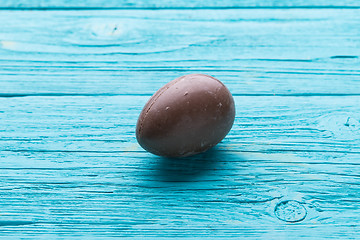 Image showing Chocolate egg on blue table