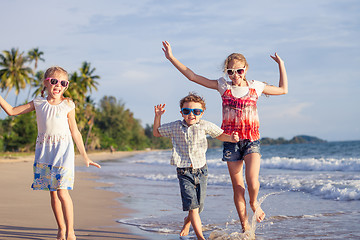 Image showing Happy children playing on the beach at the day time.