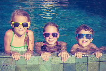 Image showing happy children  playing on the swimming pool at the day time