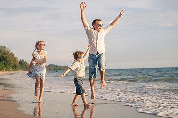 Image showing father and children playing on the coast of lake