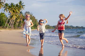 Image showing Happy children playing on the beach at the day time.