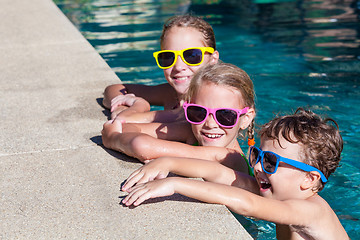 Image showing happy children  playing on the swimming pool at the day time