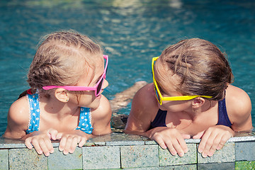 Image showing Two happy children  playing on the swimming pool at the day time