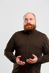 Image showing Surprised man with brown shirt