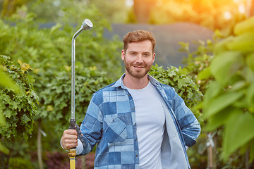 Image showing Gardener watering plants