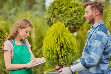 Image showing Gardeners working with papers