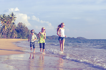 Image showing Happy children playing on the beach at the day time.