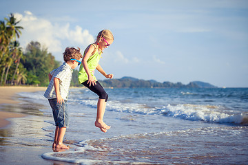 Image showing Happy children playing on the beach at the day time.