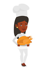 Image showing Chief cooker holding roasted chicken.