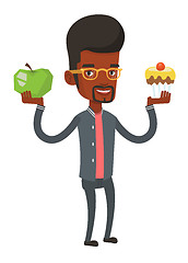 Image showing Man choosing between apple and cupcake.