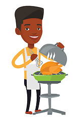 Image showing Man cooking chicken on barbecue grill.