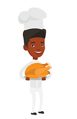 Image showing Chief cooker holding roasted chicken.